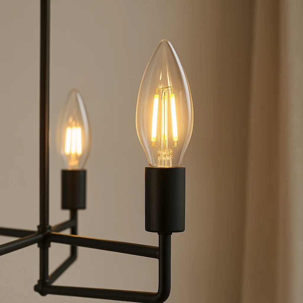 Dulora 4.2W Candle LED Bulb E14 Clear in Warm White glowing in a black modern candelabra pendant
