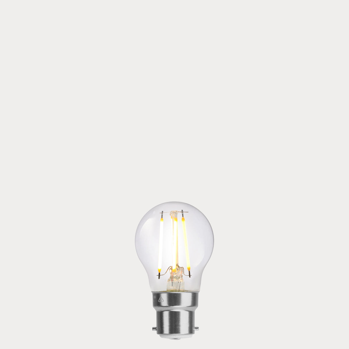 Dulora 4W Fancy Round LED Bulb B22 Clear in Warm White filaments glowing warm white 2700K