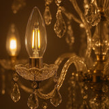 Dulora 4.2W Candle LED Bulb E14 Clear in Warm White glowing in a crystal chandelier