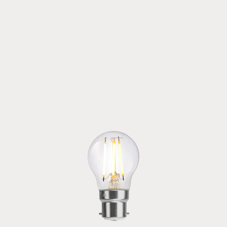 Dulora 4W Fancy Round LED Bulb B22 Clear in Warm White filaments glowing warm white 2700K