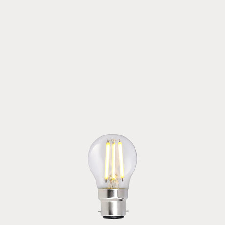 Dulora 5.5W Fancy Round LED Bulb B22 Clear in Warm White filaments glowing