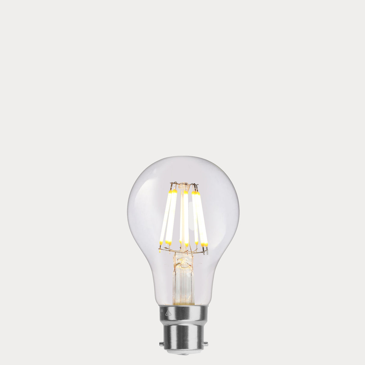 Dulora 8W 12-24 Volt AC/DC GLS LED Bulb B22 Clear in Warm White illuminated with warm glow through clear A60 glass